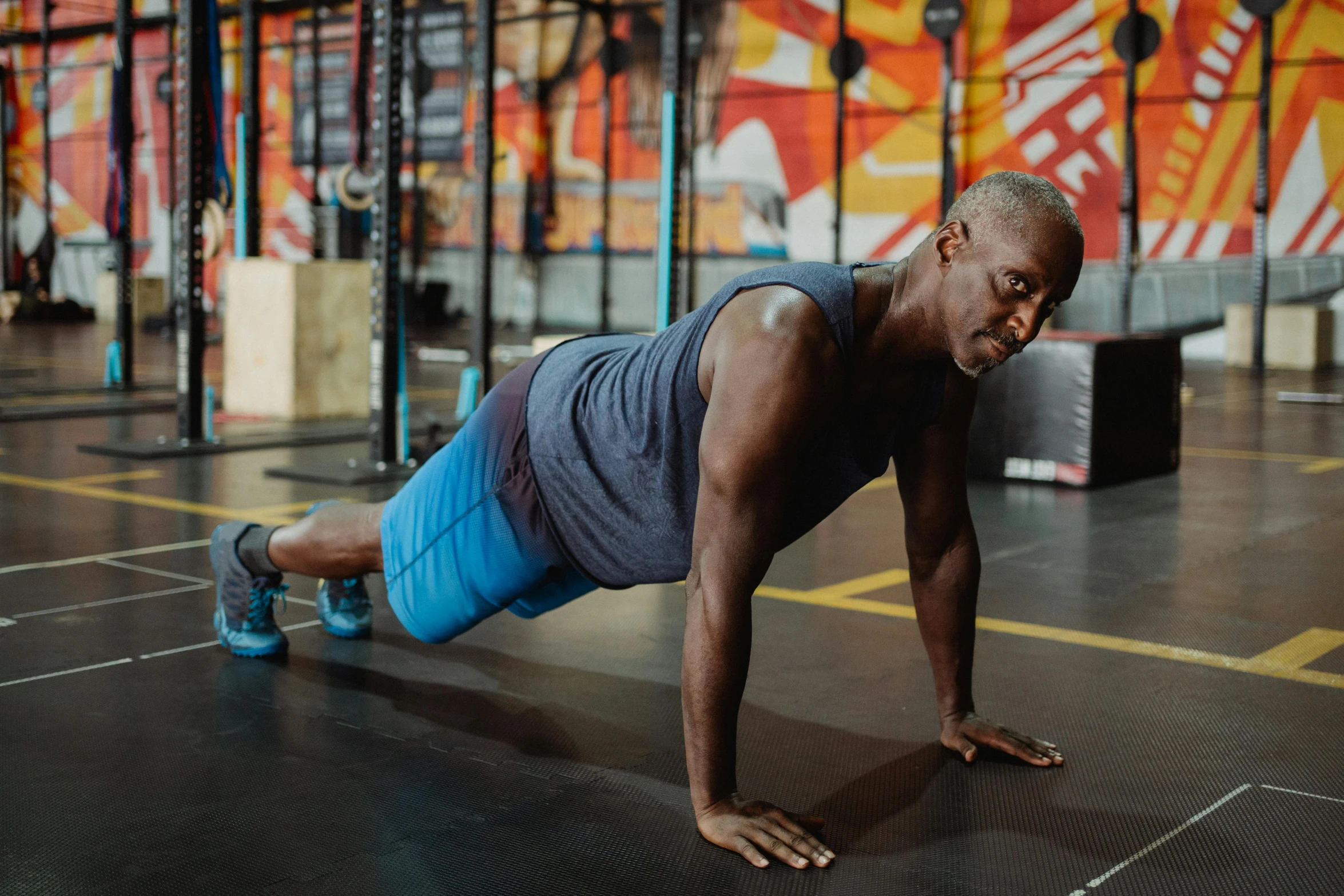 a man doing push ups in a gym, a portrait, pexels contest winner, aged 4 0, man is with black skin, background image, owen gent