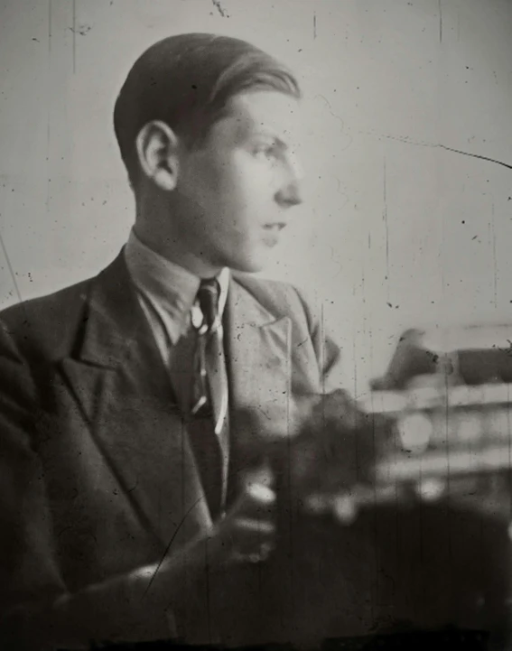 a black and white photo of a man with a typewriter, inspired by Josef Čapek, bauhaus, holding a lute, lily frank, young handsome pale roma, courtesy of moma