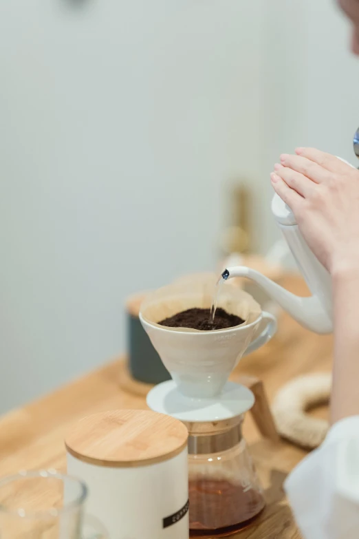 a woman pours coffee into a coffee pot, by Miyamoto, trending on unsplash, dripping blue natural iwakura, made of glazed, gif, bone