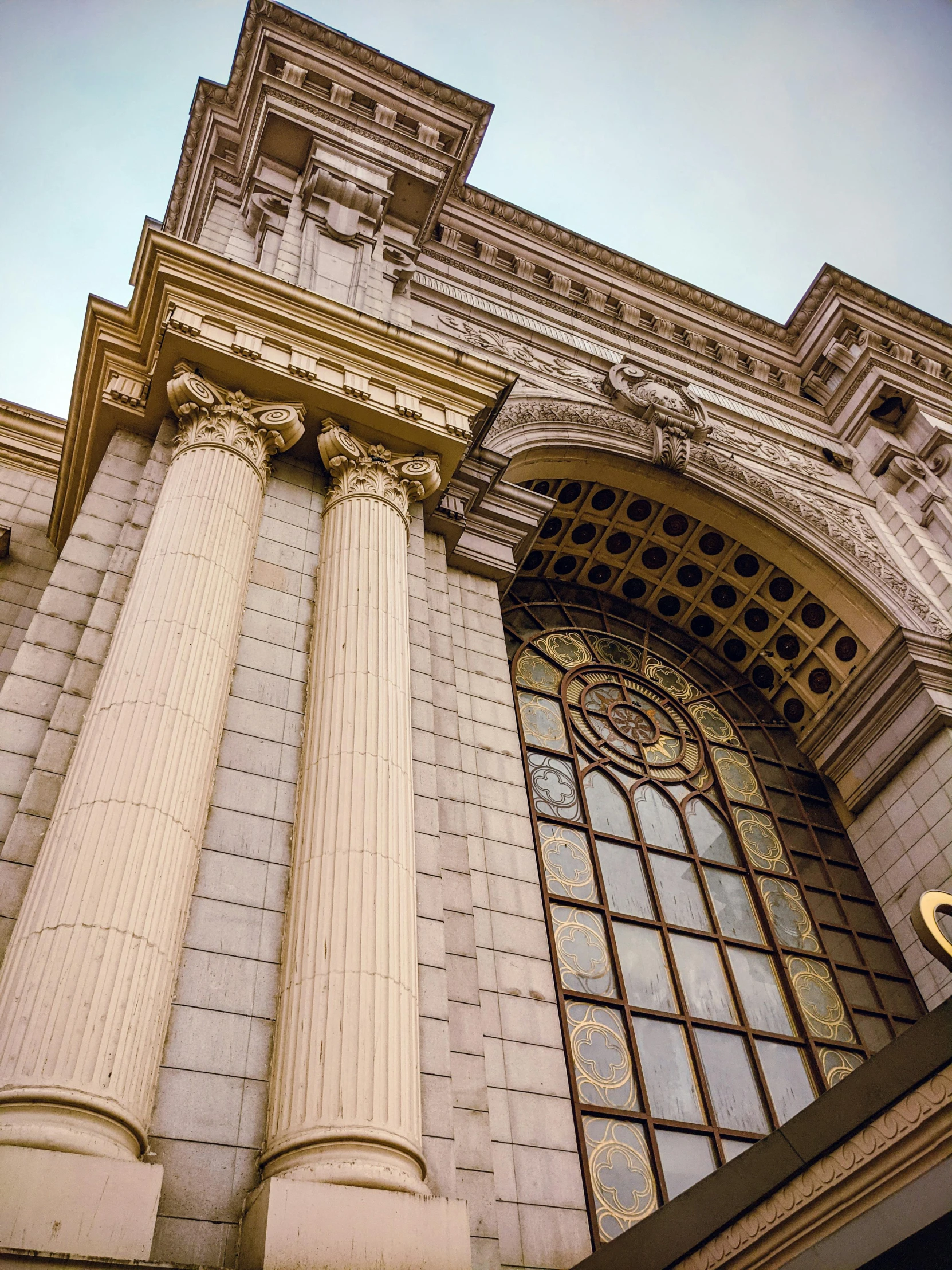 a tall building with a clock on the front of it, a photo, pexels contest winner, neoclassicism, arches adorned pillars, san francisco, profile image, khedival opera house