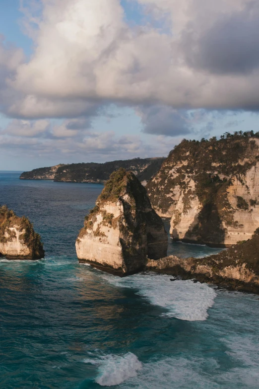 a body of water that has some rocks in it, a matte painting, pexels contest winner, renaissance, coastal cliffs, indonesia national geographic, tall arches, panoramic widescreen view