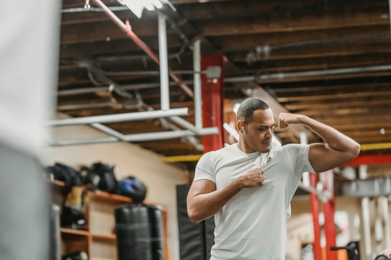 a man flexes his muscles in a gym, a portrait, by Marshall Arisman, pexels contest winner, happening, dabbing, profile image, background image, in a fighting stance