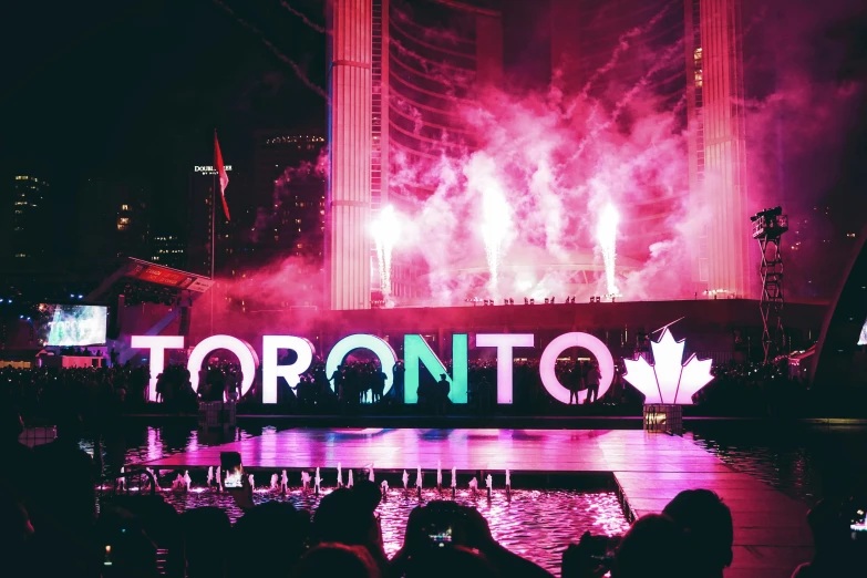 a group of people standing on top of a stage, by Julia Pishtar, pexels contest winner, graffiti, the city of toronto, floating lights, poster of a techno night, canadian maple leaves