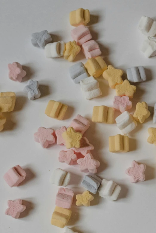 a pile of marshmallows sitting on top of a table, tiny stars, vintage shapes, sherbert sky, full product shot