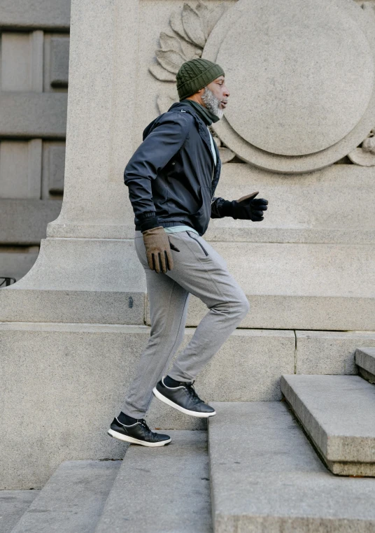 a man riding a skateboard down a flight of stairs, inspired by Salomon van Abbé, happening, gunmetal grey, cold weather, pants, running freely
