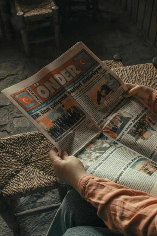 a person sitting in a chair reading a newspaper, trending on reddit, cinematic unreal engine 5, beholder, wide overhead shot, wonder