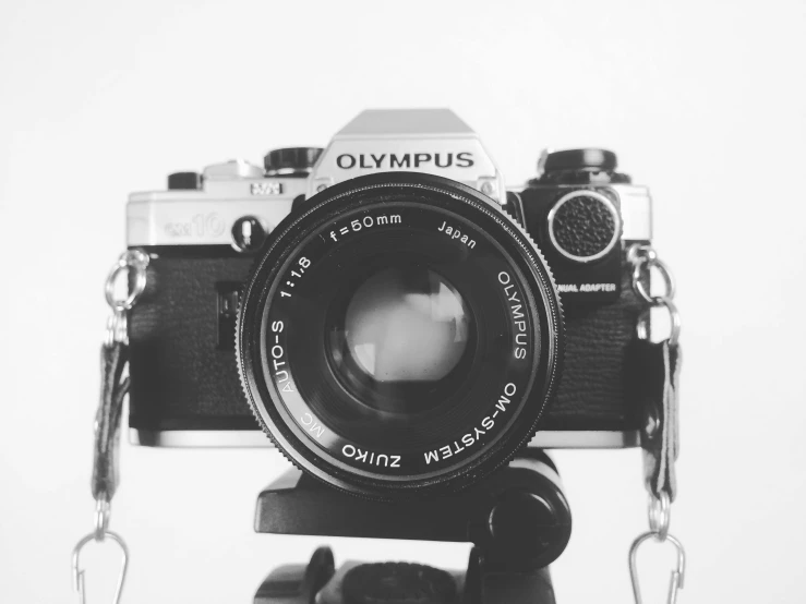 a black and white photo of a camera on a tripod, by Emma Andijewska, unsplash, olympus platform, 8 0 s camera, 4 5 mm. photorealistic, olympus