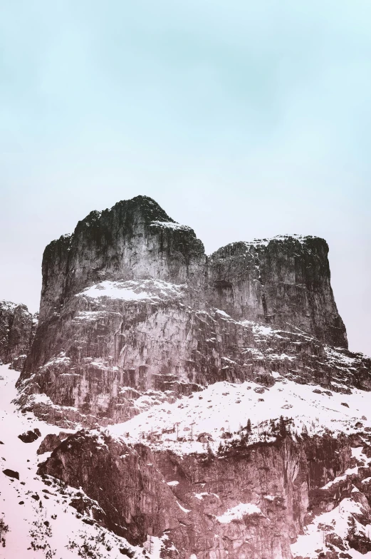 a man riding a snowboard down a snow covered slope, a colorized photo, trending on unsplash, romanticism, rock formations, giant imposing mountain, limestone, old color photo