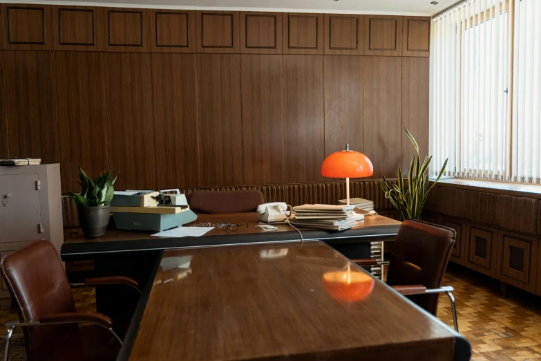 a desk that has a lamp on top of it, by Jesper Knudsen, unsplash, modernism, wes anderson movie, 1970s photo, espoo, smooth panelling