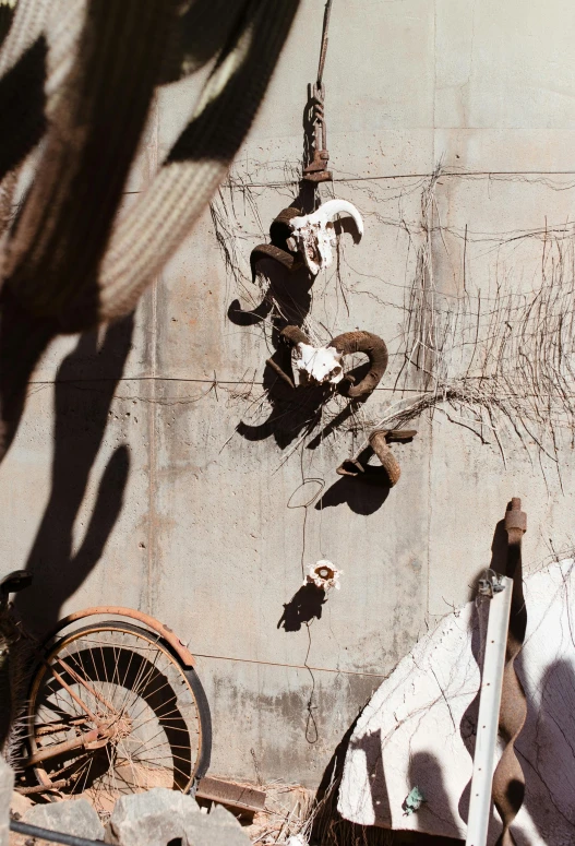 a man flying through the air while riding a skateboard, an abstract sculpture, by William Berra, pexels contest winner, with vestiges of rusty machinery, hanging beef carcasses, patchy cactus, hanging rope
