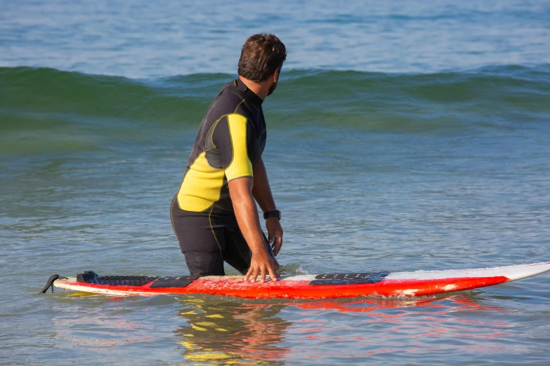 a man standing on a surfboard in the water, profile image, abel tasman, instruction, zoomed in