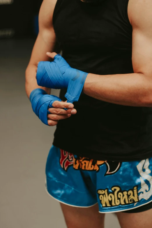 a man in a black tank top and blue boxing shorts, unsplash, hand wraps, square, decorative, character from king of fighters