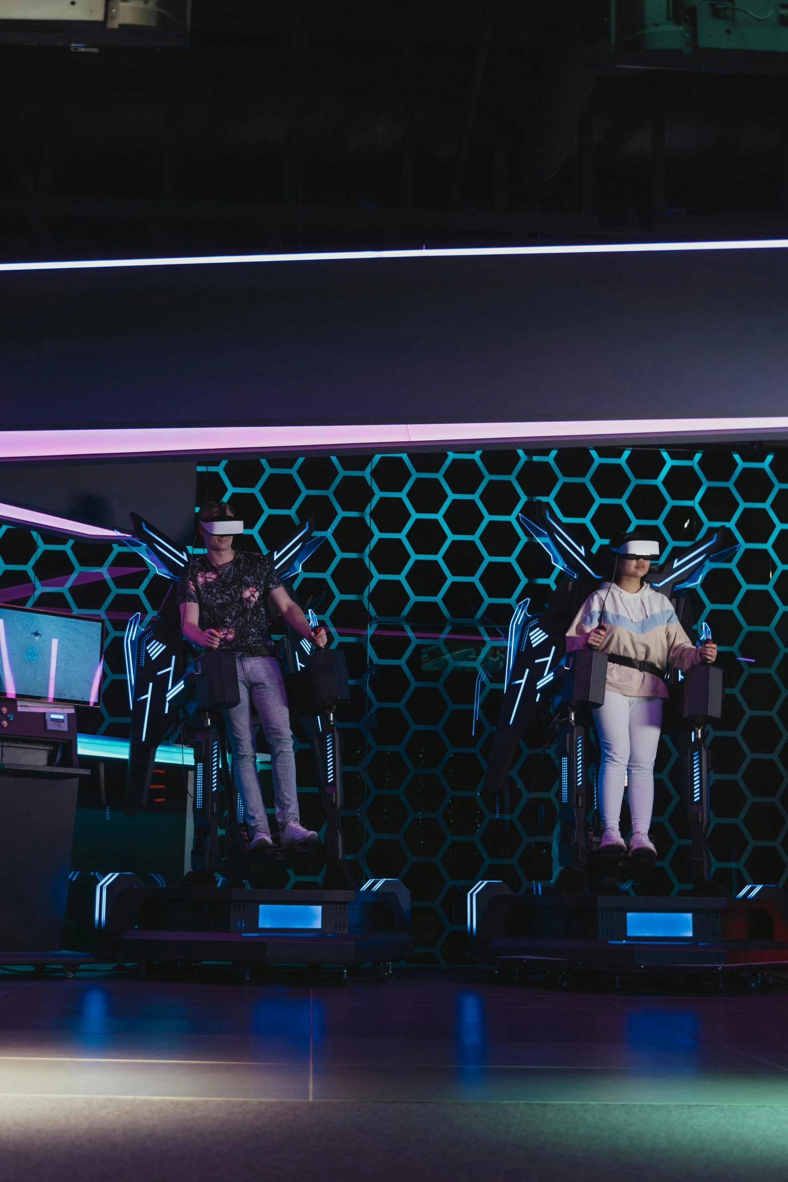 a group of people standing on top of a stage, a hologram, pexels contest winner, interactive art, vr helmet, arcade game, jetpacks, standing in a starbase bar