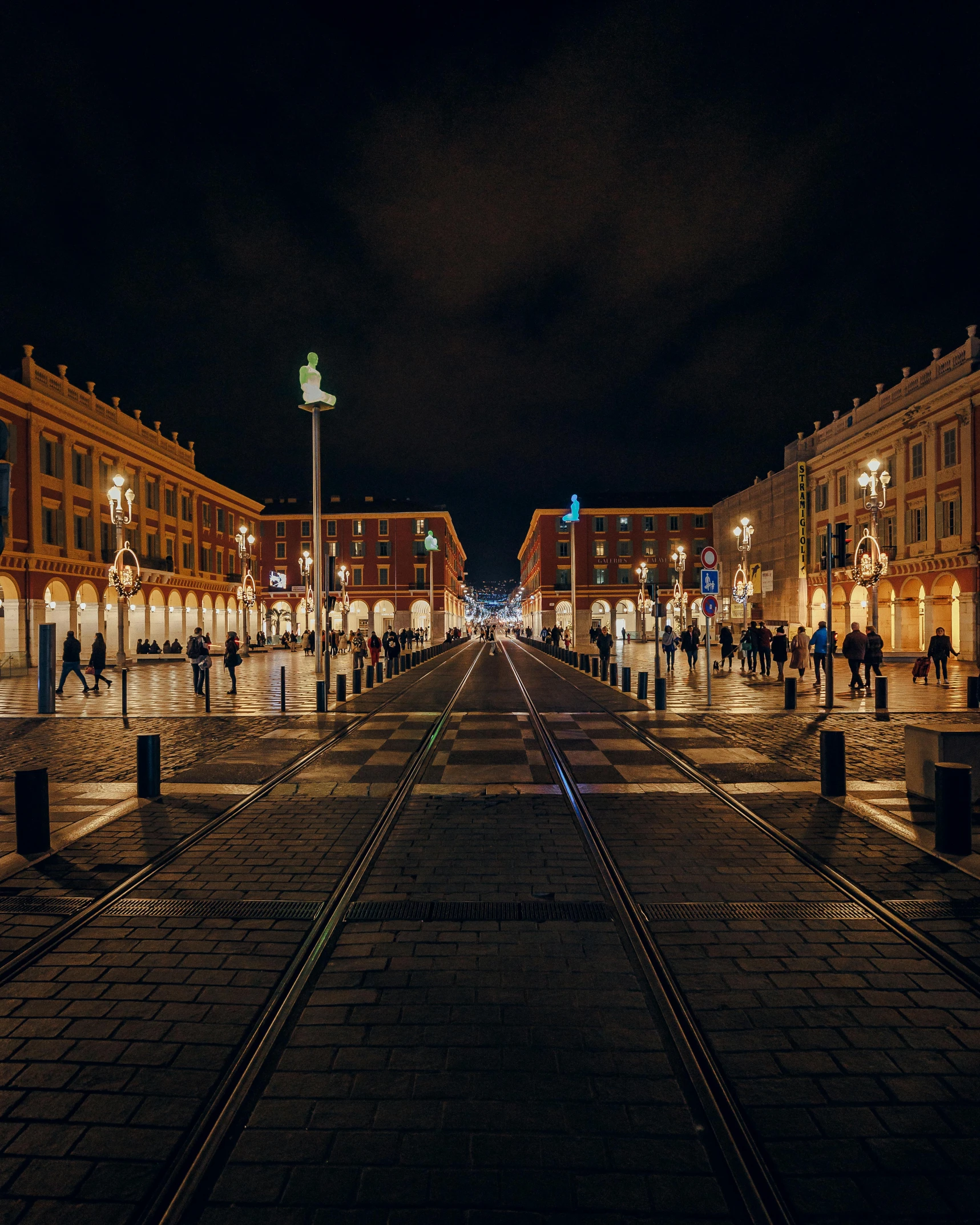 a group of people walking down a street at night, pexels contest winner, hyperrealism, on a great neoclassical square, terracotta, train station, port