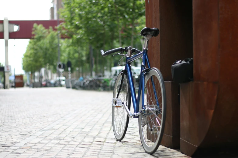 a bicycle leaning against the side of a building, profile image, prussian blue, clean streets, overview