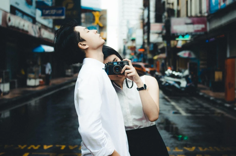 a man taking a picture of a woman with a camera, pexels contest winner, ruan jia and brom, profile posing, street pic, holding each other