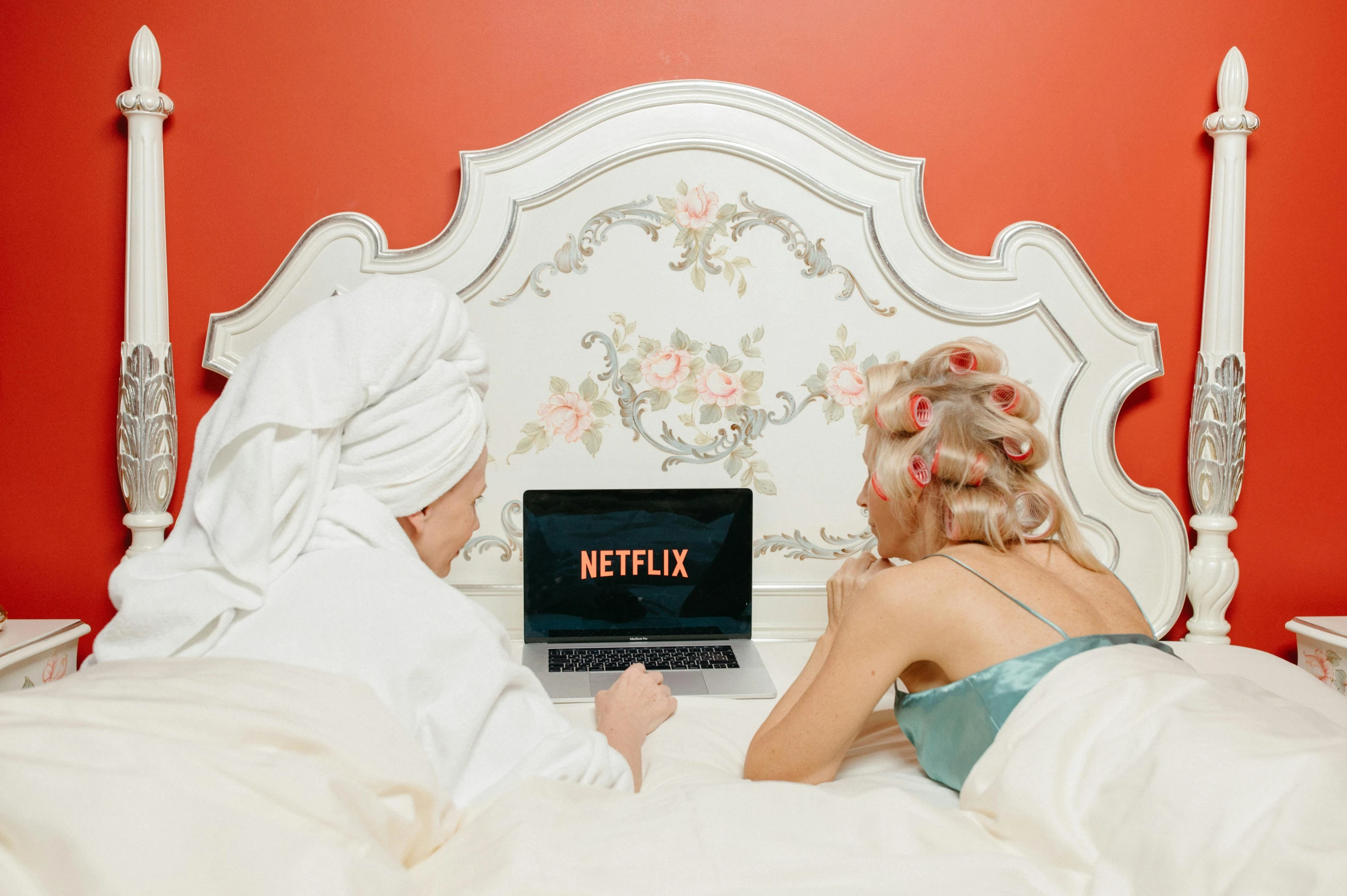 a couple of people laying in bed with a laptop, by Julia Pishtar, trending on pexels, serial art, fancy dress, at netflix, her back is to us, netfilx !n-9