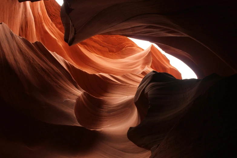 a view of the inside of a canyon, an abstract sculpture, by Jessie Algie, pexels contest winner, ancient swirls, softly shadowed, reddish, photographed for reuters