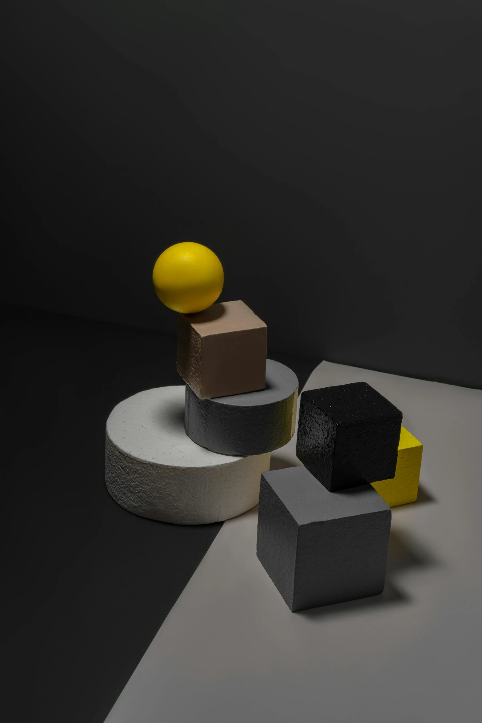 a group of cubes sitting on top of a table, an abstract sculpture, inspired by Bauhaus, unsplash, charcoal and yellow leather, sphere, shot with sony alpha, square