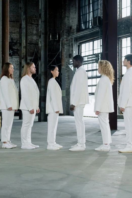 a group of people standing next to each other, inspired by Vanessa Beecroft, antipodeans, white suit, wearing track and field suit, profile posing, holy ceremony