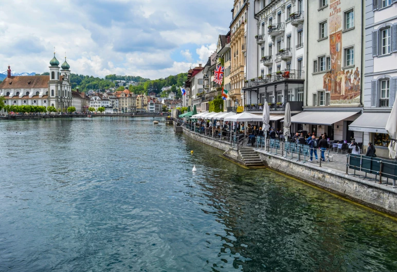 a river running through a city next to tall buildings, by Julia Pishtar, pexels contest winner, renaissance, photo of zurich, al fresco, square, thumbnail