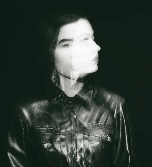 a black and white photo of a woman in a leather jacket, inspired by Elsa Bleda, unsplash, conceptual art, transparent face, björk, unknown artist, dua lipa