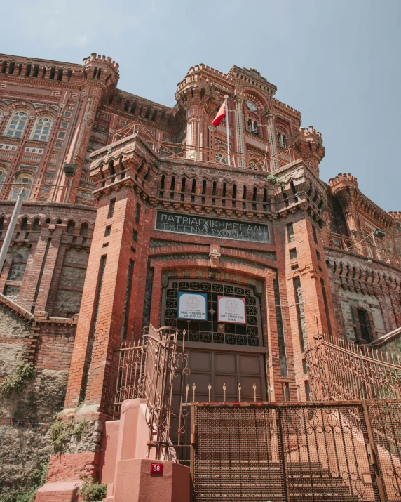 a red brick building with a gate in front of it, an album cover, pexels contest winner, quito school, opalescent palace, manila, thumbnail, brown
