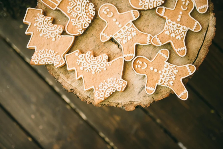 a bunch of cookies sitting on top of a piece of wood, by Emma Andijewska, pexels contest winner, folk art, laser cut, holiday vibe, caramel, thumbnail
