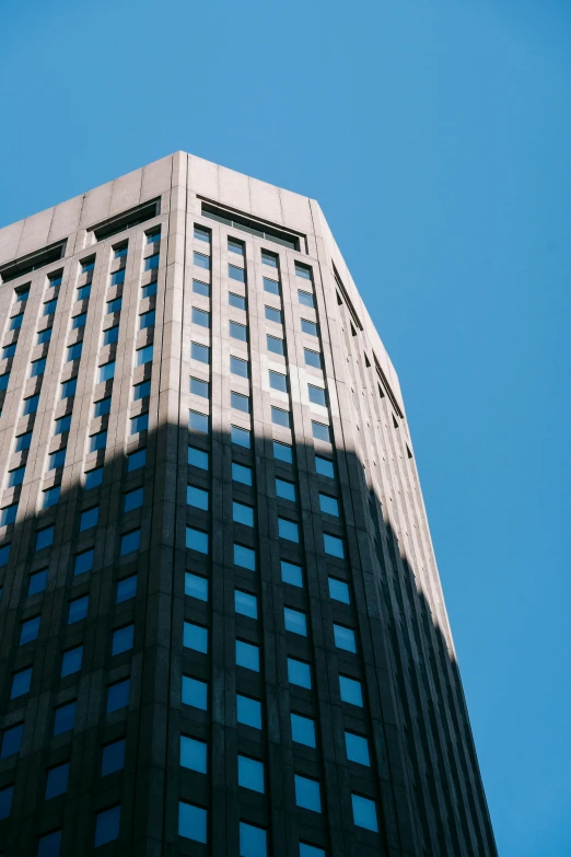 a tall building with a blue sky in the background, unsplash, pittsburgh, fujicolor photo, fan favorite, brown