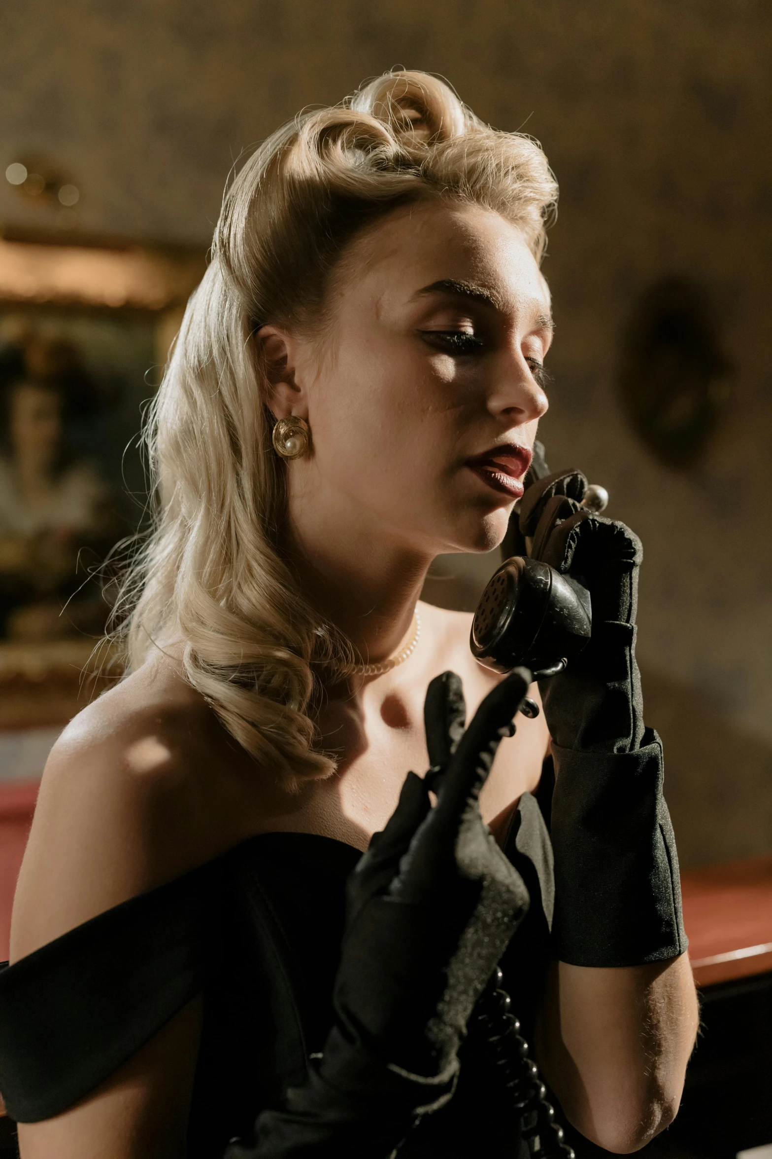 a woman in a black dress talking on a phone, inspired by Evaline Ness, trending on pexels, surrealism, leather gloves, margot robbie, ( ( theatrical ) ), golden age