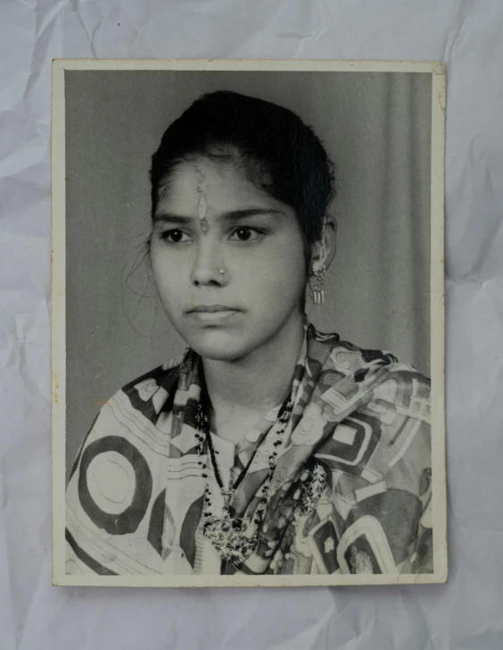 a black and white photo of a woman, a black and white photo, flickr, bengal school of art, 8 0 s polaroid photo, traditional portrait, 2 2 years old, taken in 2022