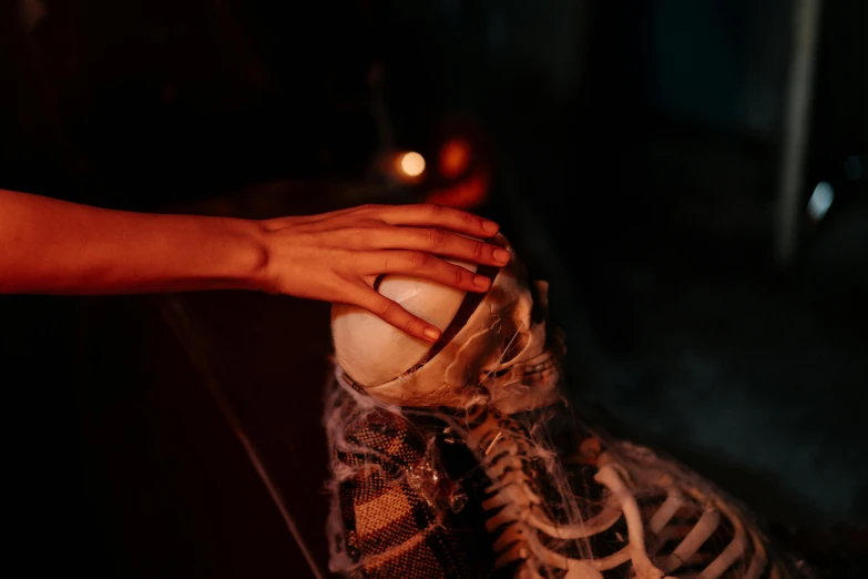 a close up of a person's hand touching a shoe, inspired by Elsa Bleda, vanitas, glowing bones, looking across the shoulder, samhain figure, ash thorp