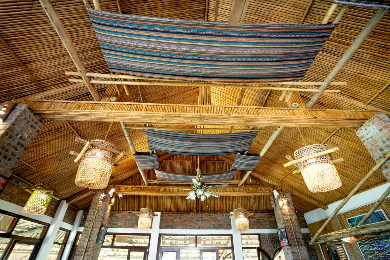 a hammock hanging from the ceiling of a restaurant, bamboo huts, indoor picture, awnings, thumbnail