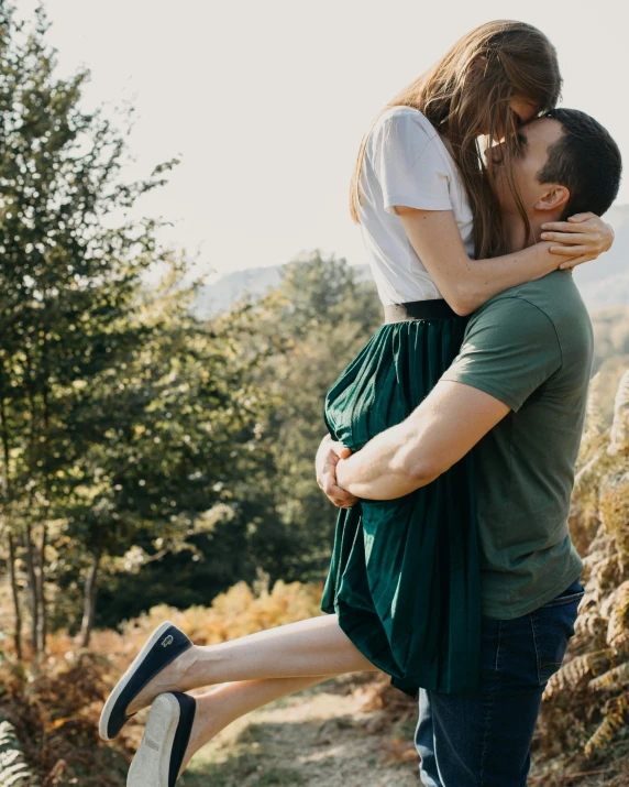 a man carrying a woman on his back, by Emma Andijewska, pexels contest winner, romanticism, white shirt and green skirt, kissing together cutely, 15081959 21121991 01012000 4k, in the hillside