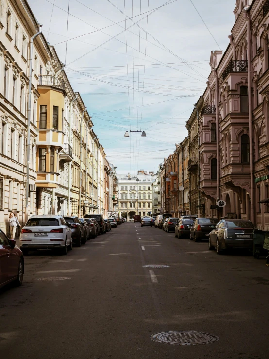 a street lined with parked cars next to tall buildings, by Alexander Runciman, pexels contest winner, neoclassicism, saint petersburg, wires hanging above street, 000 — википедия, square