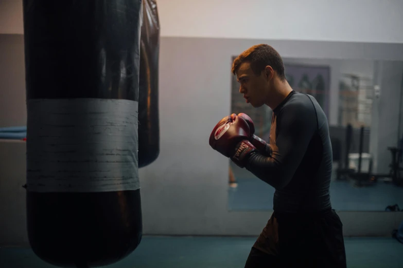 a man standing next to a punching bag, pexels contest winner, happening, justin sun, train with maroon, ( ( theatrical ) ), profile image