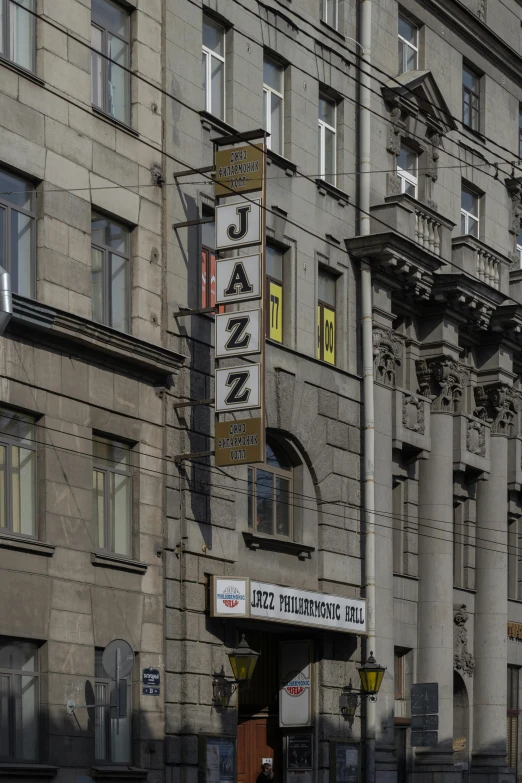 a tall building sitting on the side of a street, an album cover, by László Balogh, old signs, jazza, in moscow centre, gray