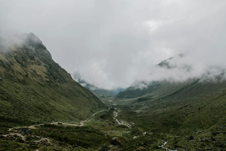 a river running through a lush green valley, by Daniel Lieske, trending on unsplash, hurufiyya, peruvian looking, under a gray foggy sky, ignant, panorama view