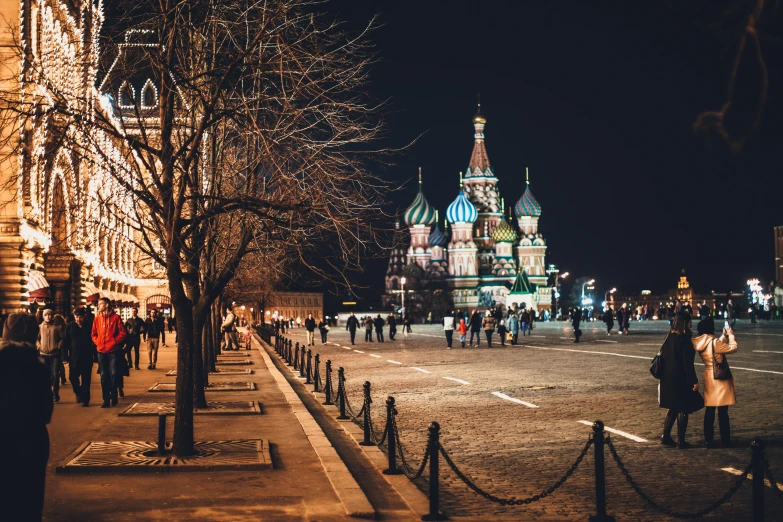 a group of people walking down a street at night, russian architecture, profile image, parks and monuments, 🚿🗝📝