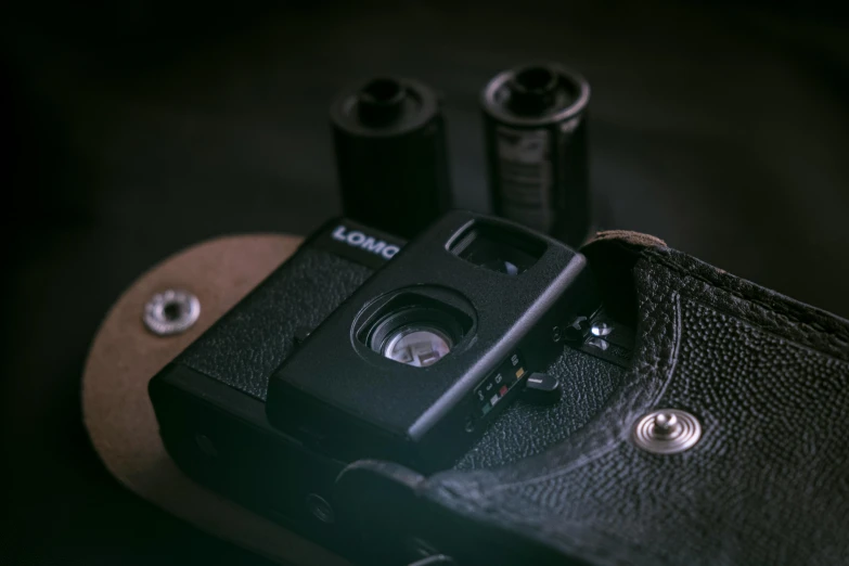 a camera sitting on top of a leather case, unsplash, lomo, pov camera looking into the maw, low-key, shot of film