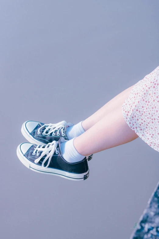 a close up of a person holding a pair of shoes, by Eizan Kikukawa, unsplash, little girl, converse, 15081959 21121991 01012000 4k, panoramic view of girl