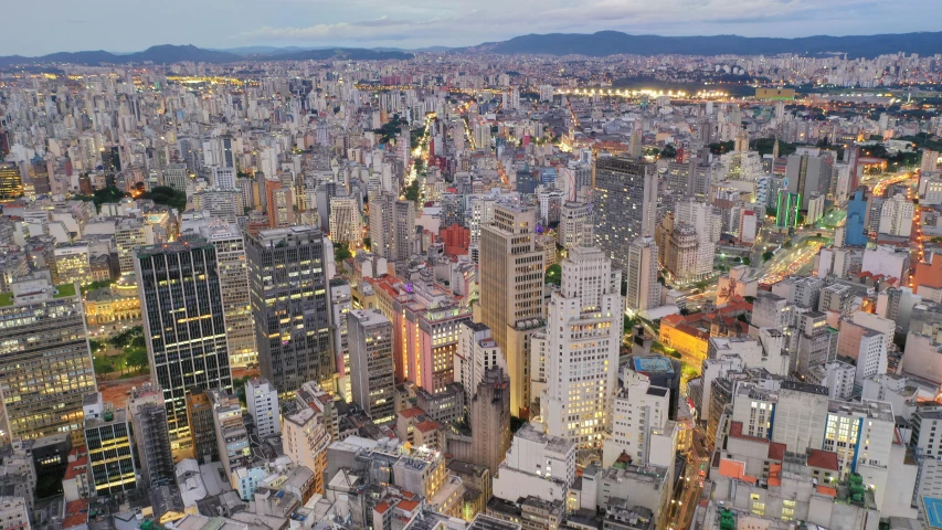 an aerial view of a city at night, by Ceferí Olivé, pexels contest winner, helio oiticica, tall buildings on the sides, edu souza, youtube thumbnail