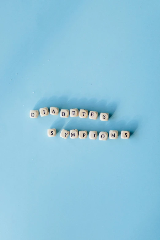 the word diabetes spelled with wooden letters on a blue background, an album cover, by Daniel Lieske, pexels, happening, 256x256, sorrow, worried, squares