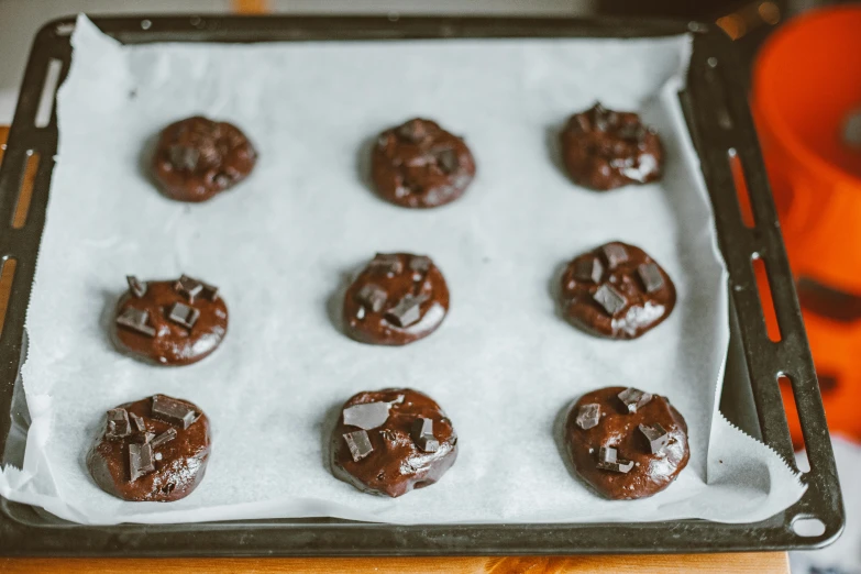 a tray of chocolate cookies sitting on top of a table, by Julia Pishtar, sticky black goo, instructions, thumbnail, handcrafted