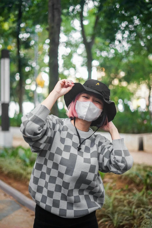 a woman with a mask covering her face, inspired by Oka Yasutomo, trending on pexels, baggy clothing and hat, 8 0 s checkerboard 6 6 6, jakarta, discord profile picture