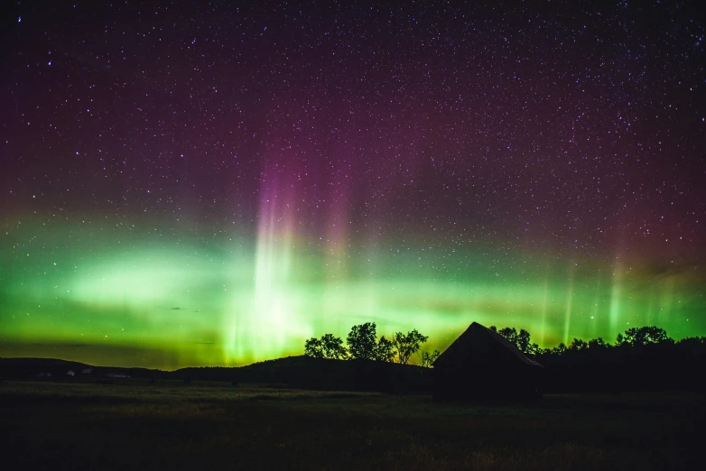 a green and purple aurora bore in the sky, a picture, by Robert Storm Petersen, unsplash contest winner, prairie, vacation photo, big sky, instagram post