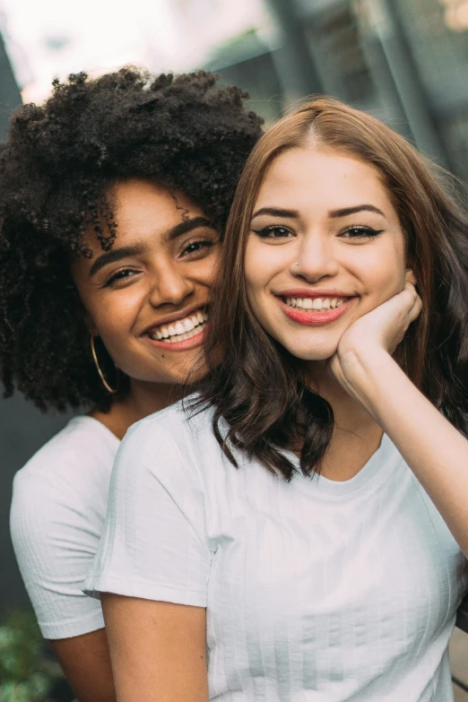 a couple of women standing next to each other, trending on unsplash, mixed race woman, portrait of women embracing, 15081959 21121991 01012000 4k, smiling girl