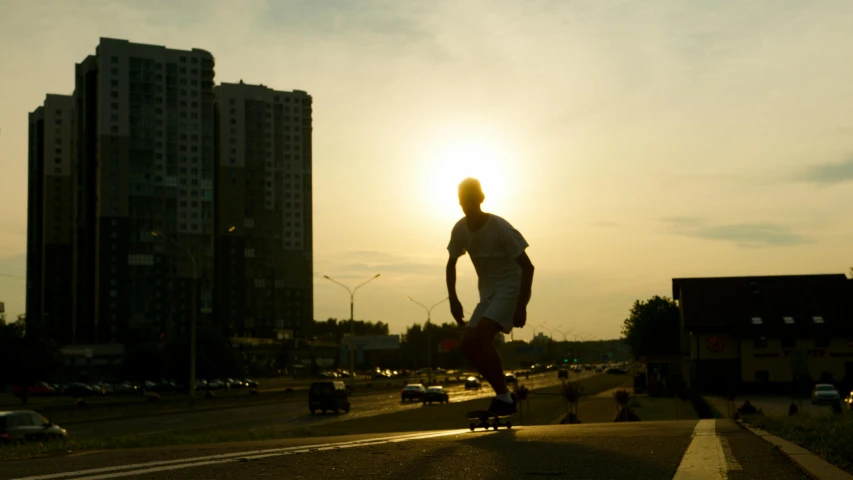 a man riding a skateboard down the side of a road, by Alexey Venetsianov, city sunset, sunday afternoon, back - lit, moscow