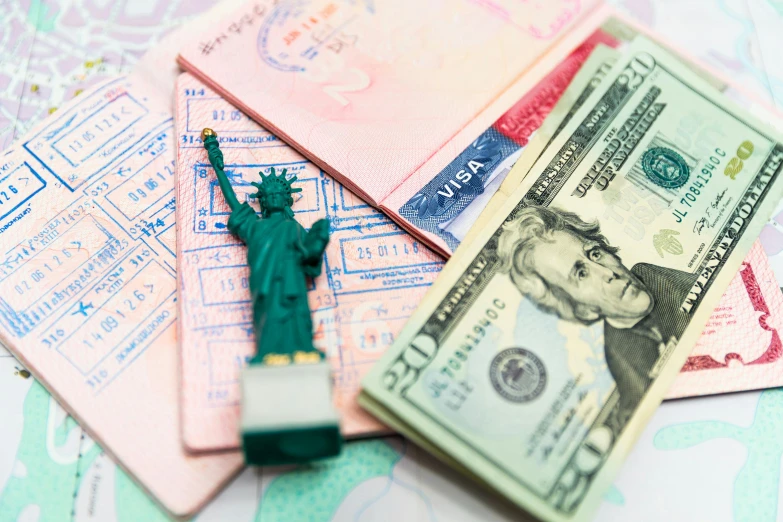 a passport, money, and a statue of liberty on a map, by Daniel Lieske, shutterstock, a brightly colored, papers on table, 🚿🗝📝