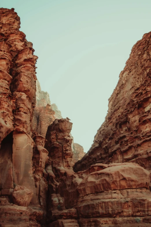 a person riding a horse through a canyon, by Ahmed Yacoubi, unsplash contest winner, les nabis, highly detailed rock structures, sunfaded, view from the streets, slightly pixelated